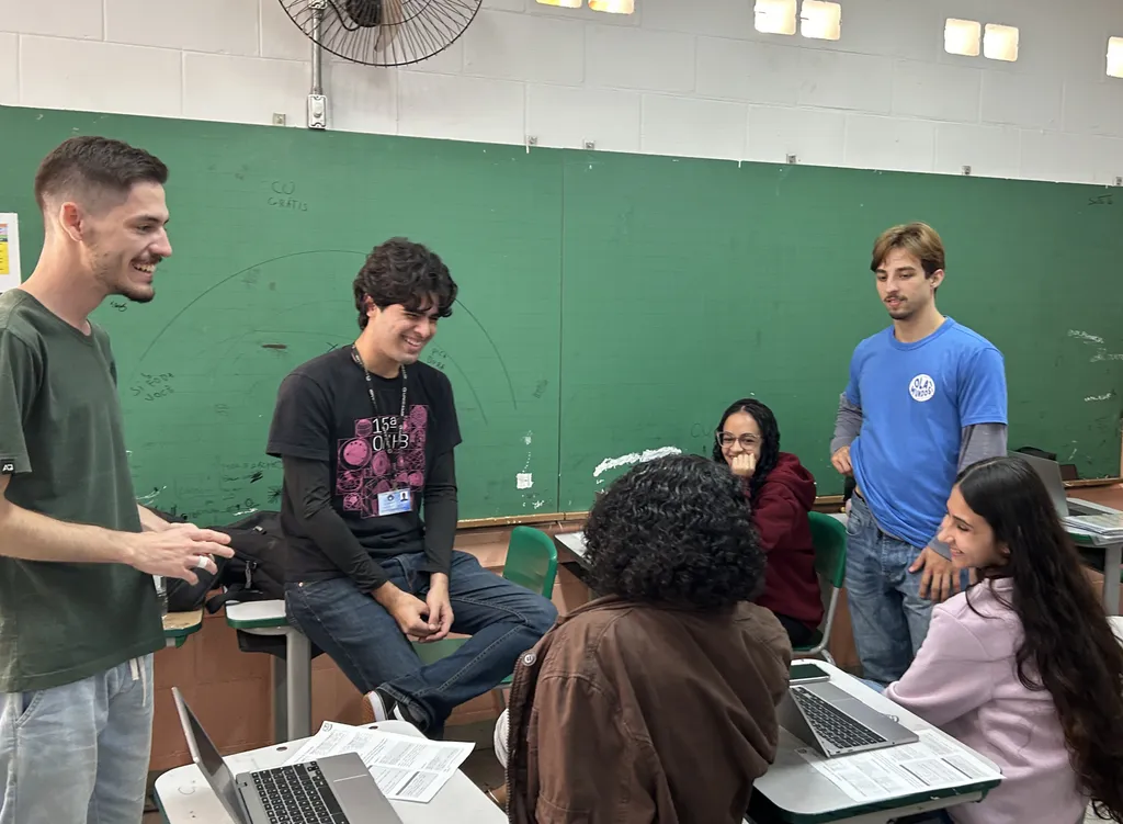 Professores do projeto e alunos sorrindo durante uma conversa